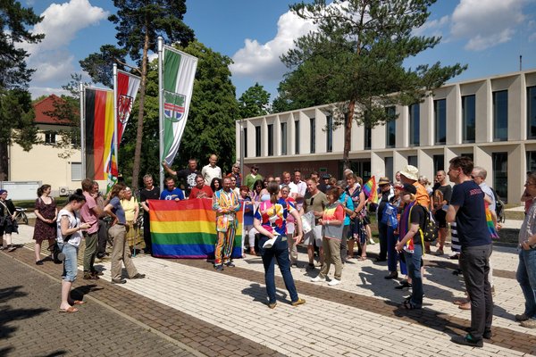 Rund 100 Bürgerinnen und Bürger protestieren vor dem Dallgower Rathaus für Toleranz und Vielfalt, nachdem die Regenbogenflagge angezündet worden war. 